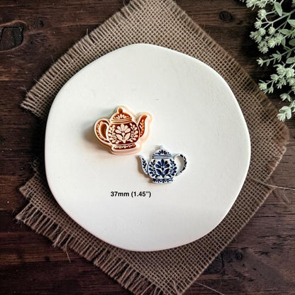 Matching folk teapot cutter and finished clay piece displayed together on a white plate with text showing the size as 37mm.