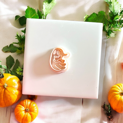 Silly Ghost polymer clay cutter centered on white tile with pumpkin accents